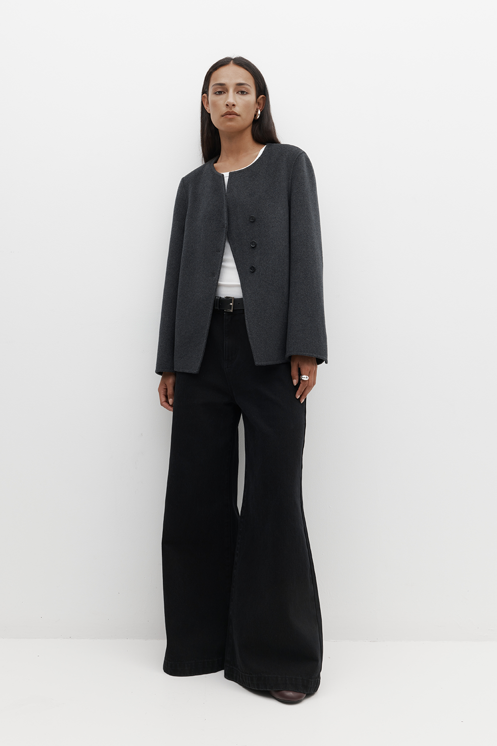 REBE Coco Jacket in charcoal styled on model, showcasing its soft cashmere-wool texture, asymmetric front, and boxy fit.\
